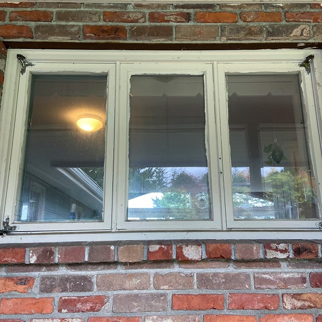 A dirty window before a window cleaning service from Pure Shine.